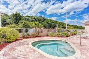 A swimming pool with a brick border, surrounded by a fence and greenery, with a clear sky above. - 1 Block From the Beach, Next to Ft Clinch State Park and 2 Miles From Historic Centre Street (Fernandina Beach)
