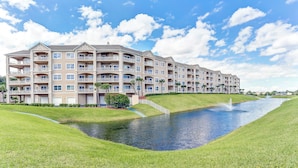 A multi-story hotel with balconies, a swimming pool, and a fountain. - 1 Block From the Beach, Next to Ft Clinch State Park and 2 Miles From Historic Centre Street (Fernandina Beach)