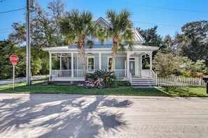 A two-story house with a porch, palm trees, and a stop sign. - 1016 San Fernando Street (Fernandina Beach)