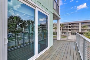 A balcony with a view of neighboring buildings and parked cars. - 391 South Fletcher A&B (Fernandina Beach)