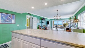 A kitchen with a large island, a dining area with a view, and a living space with a view. - A1 Amelia South (Fernandina Beach)