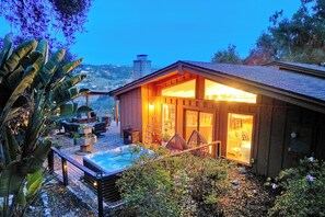 A cozy wooden cabin with a hot tub, outdoor seating, and a view of the hills. - 3046 Skycrest Drive (Fallbrook)