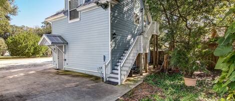 A two-story house with a front porch, a staircase, and a small attached garage.