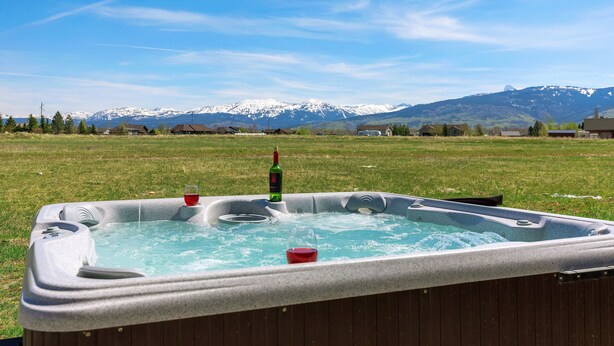 A hot tub in a grassy field with a mountain backdrop. - Teton Harmony (Driggs)