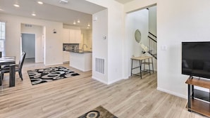 A modern interior with a dining area, kitchen, living room, and staircase. - Charming 3BR Retreat - Perfect for Families! (Fort Collins)