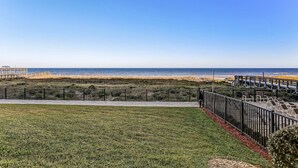 A beach view with a wooden deck and lounge chairs. - J1 Amelia South (Fernandina Beach)