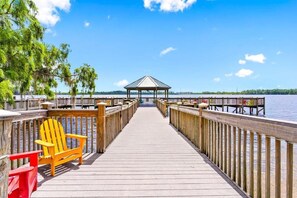 A wooden pier leading to a gazebo with a view of the water. - 13415 Blue Herron Beach DR (Orlando)