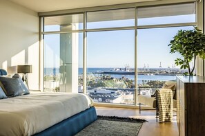 A bedroom with a large window offering a city view. - @ Marbella Lane - Luxurious 3BR Penthouse (Long Beach)