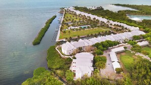 An aerial view of a resort with multiple buildings, a dock, and a waterway. - Waterfront Luxury Villa 19 With Sunset Views and Boat Slip (Marathon)