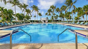 A pool with lounge chairs and palm trees. - Waterfront Luxury Villa 19 With Sunset Views and Boat Slip (Marathon)