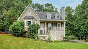 A two-story house with a wrap-around porch and a small balcony. - 1356 Velvet Creek Glen, Marietta (Marietta)
