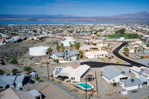 A residential area with houses, a large white water tank, and a swimming pool. - Talley it up to a Great Time in Havasu! (Lake Havasu City)