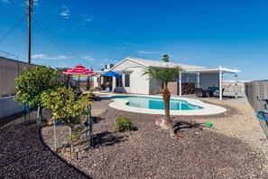 A backyard with a swimming pool, a covered patio, and a fenced area. - Talley it up to a Great Time in Havasu! (Lake Havasu City)