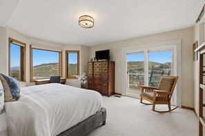 A bedroom with a bed, dresser, chair, and a television. - Ridge Home | Ski-in, Ski-out (Park City)