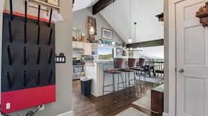 A kitchen with a central island, bar stools, and a view of the outdoors. - Ridge Home | Ski-in, Ski-out (Park City)