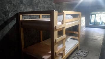 A bunk bed with a wooden frame and a mattress.