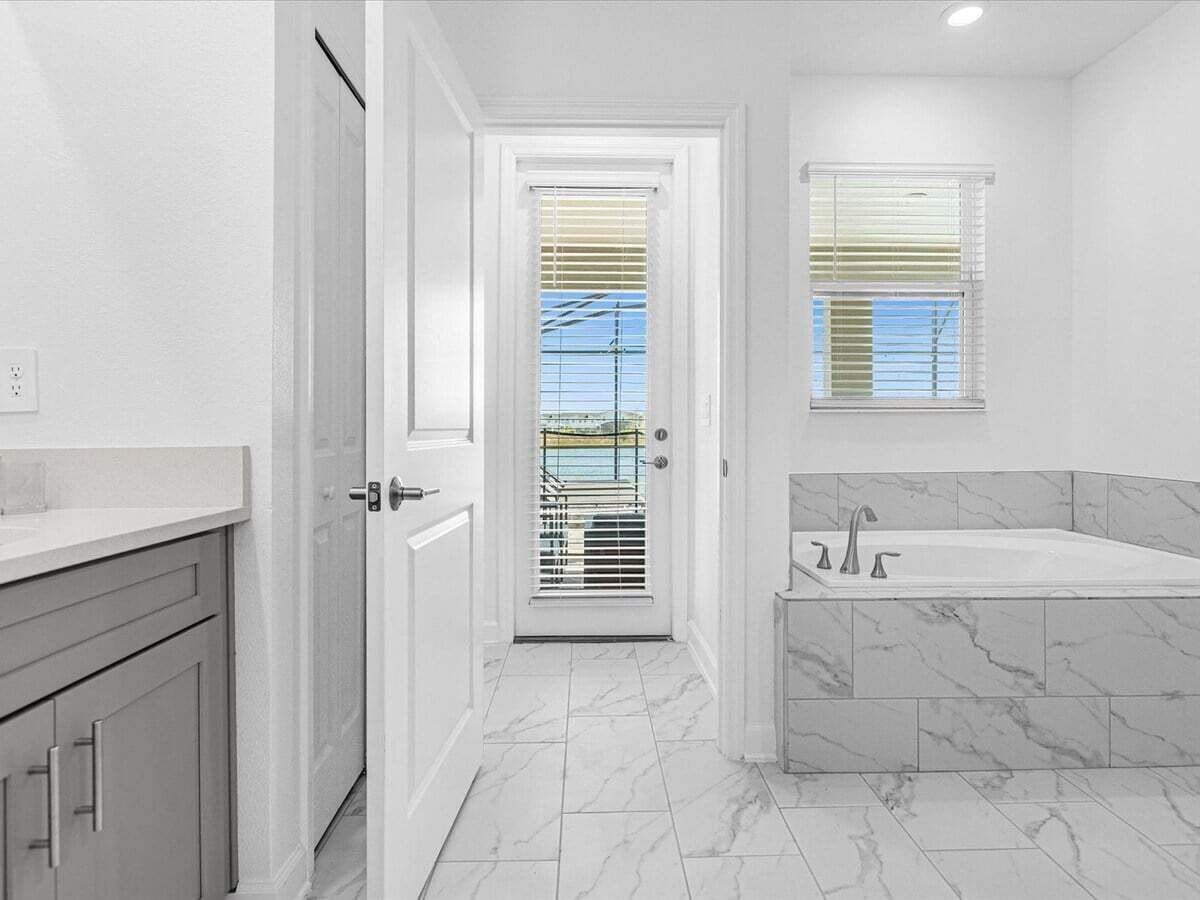 A bathroom with a bathtub, a toilet, and a sink.