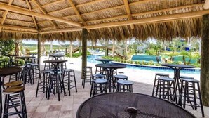An outdoor patio with tables and chairs, a pool, and a view of the landscape. - 4184pd · 20% OFF Weekly Stay/ 5br/free Water Park (Kissimmee)