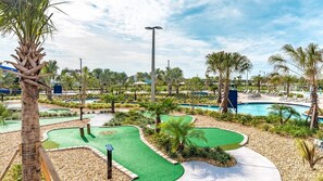 A golf course with multiple greens, a large pool, and palm trees. - Gas3070 (Kissimmee)