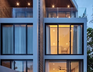 A modern multi-story building with large windows and balconies.