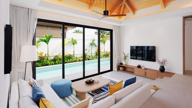 A modern living room with a large sliding glass door leading to a pool area, a ceiling fan, and a flat-screen TV. - Discover a private pool villa designed for comfortable long-term living. (Tambon Rawai)