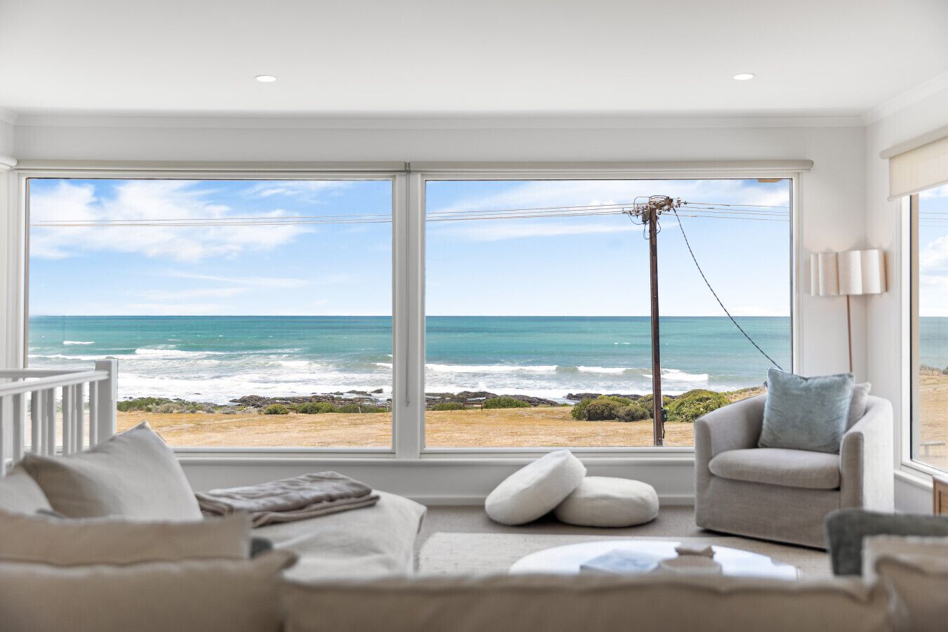 Relax on the sofa as uninterrupted ocean views stretch across Basham Beach, bringing the rhythm of the waves right into the living space.
