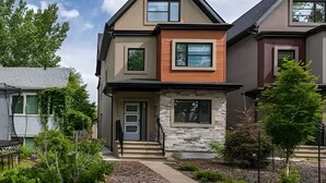 A modern two-story house with a stone facade, a front porch, and a well-maintained garden. - Lux New House by UA/Train/Rogers Place/Hospital/Ravine/AC/D-garage/sleep 12 (Edmonton)