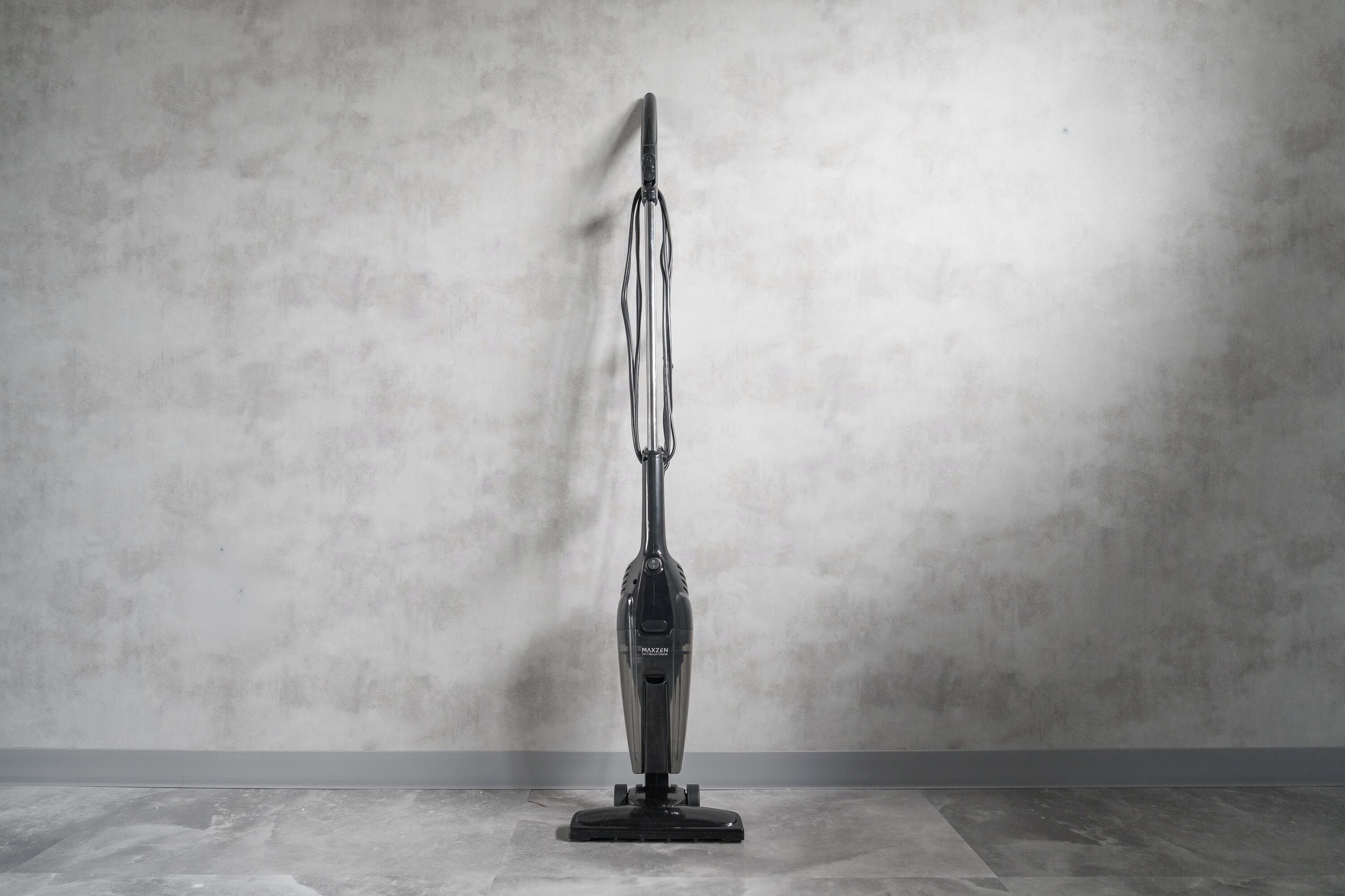 A vacuum cleaner against a plain wall.