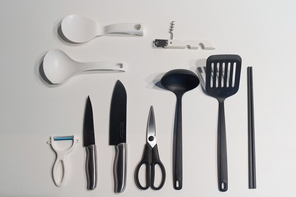 A collection of kitchen utensils and tools laid out on a white surface. - THE HALCYON (Sapporo)