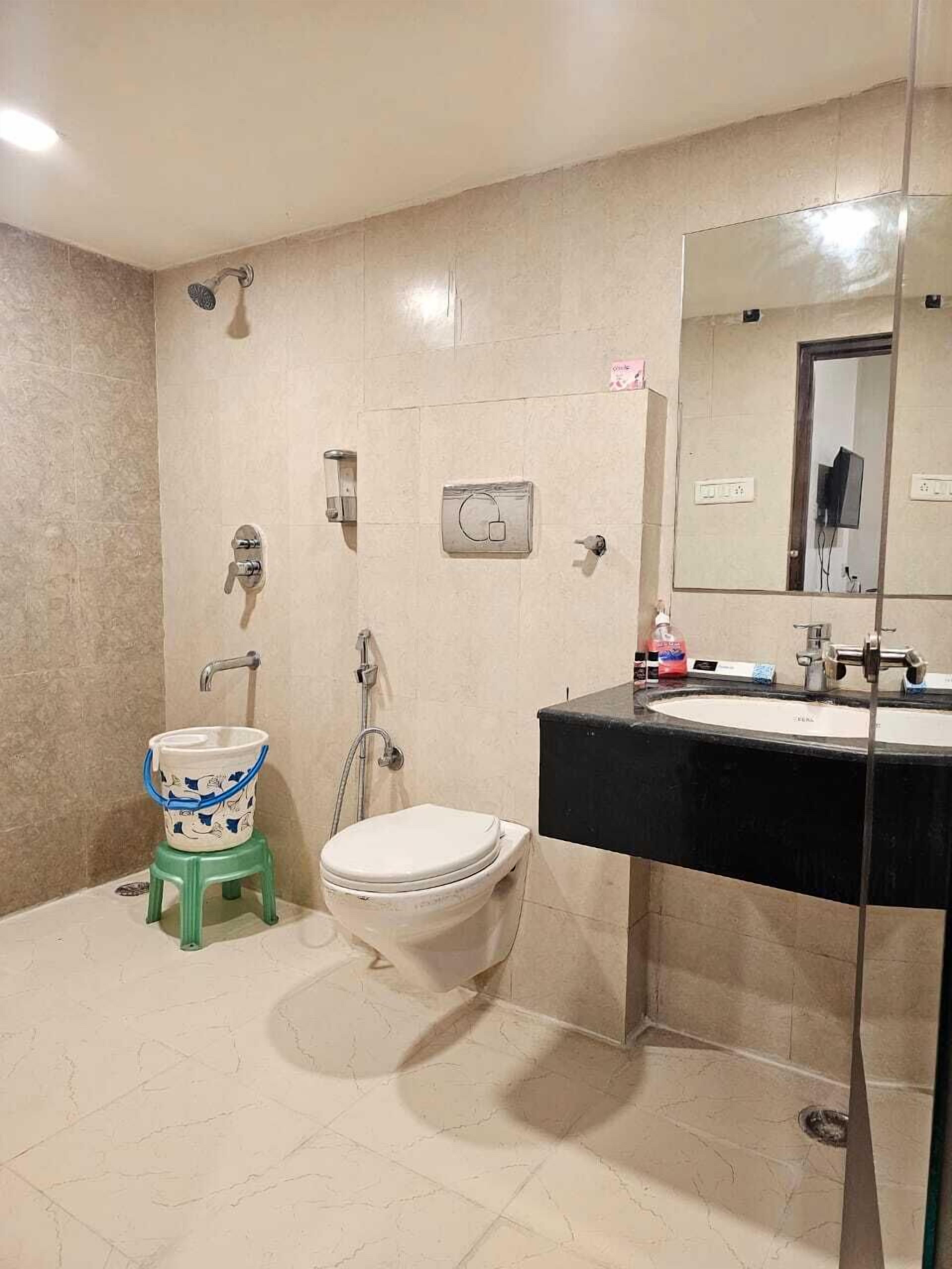 A bathroom with a toilet, bidet, and sink.
