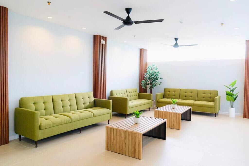 A modern living room with a sofa, armchairs, a coffee table, and a ceiling fan.