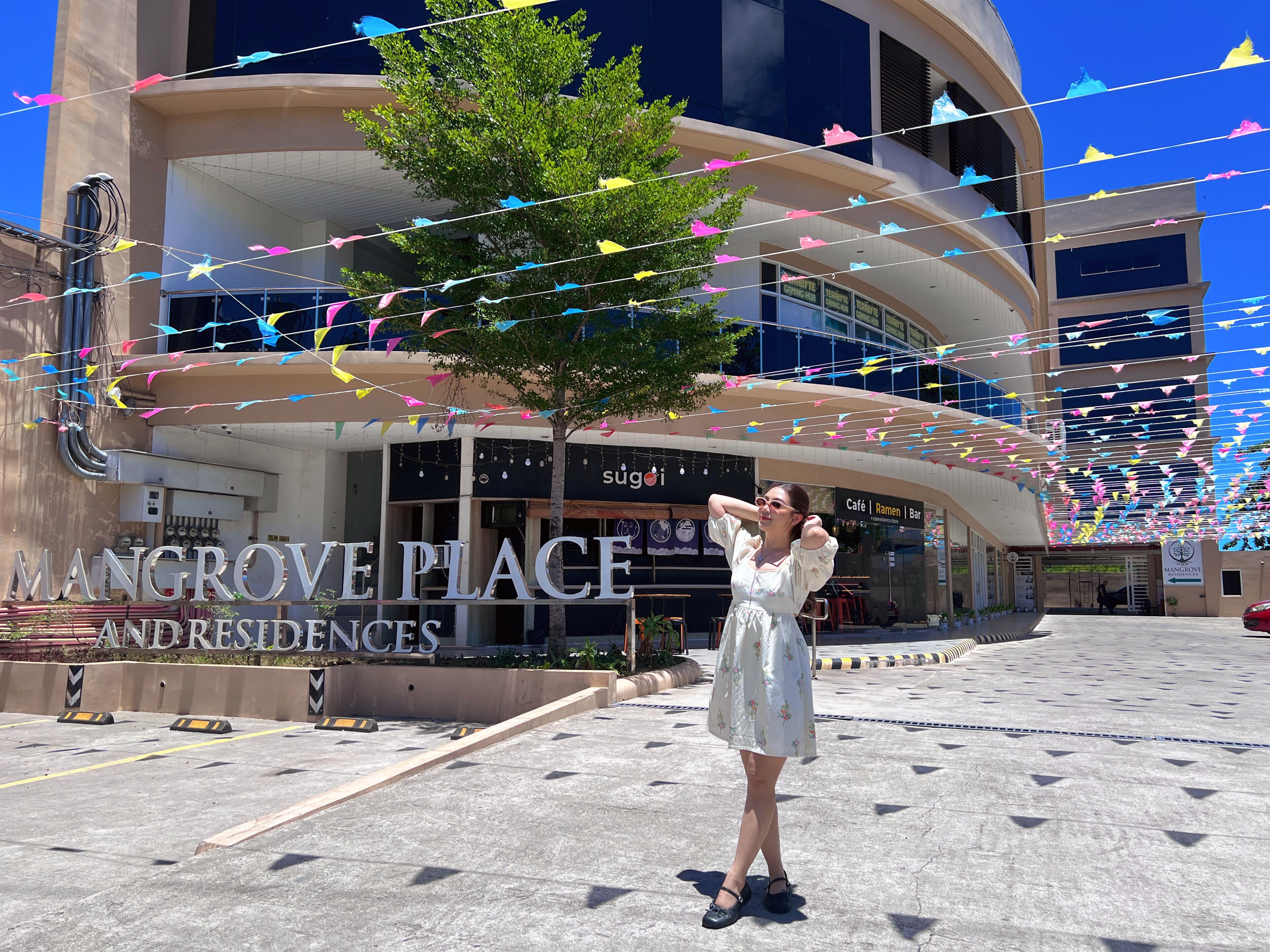 A building with signage for 'Mangrove Place and Residences.'