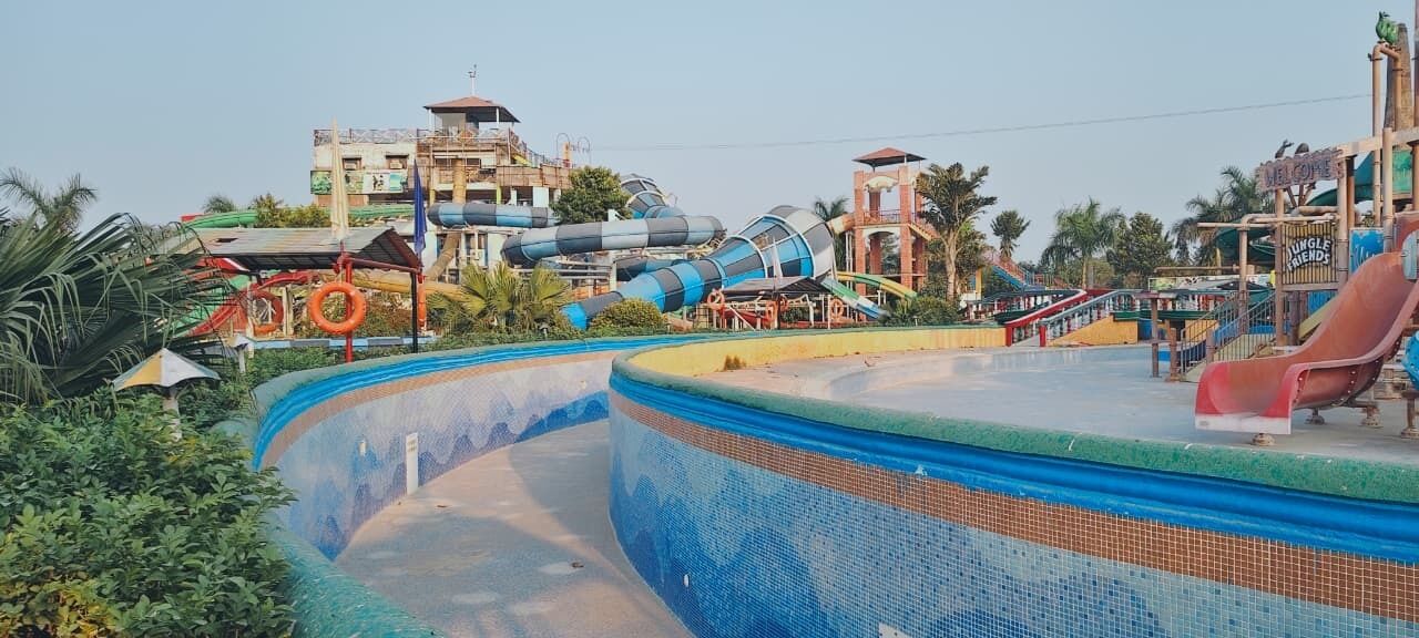 A water park with a pool, slides, and a jungle-themed area.