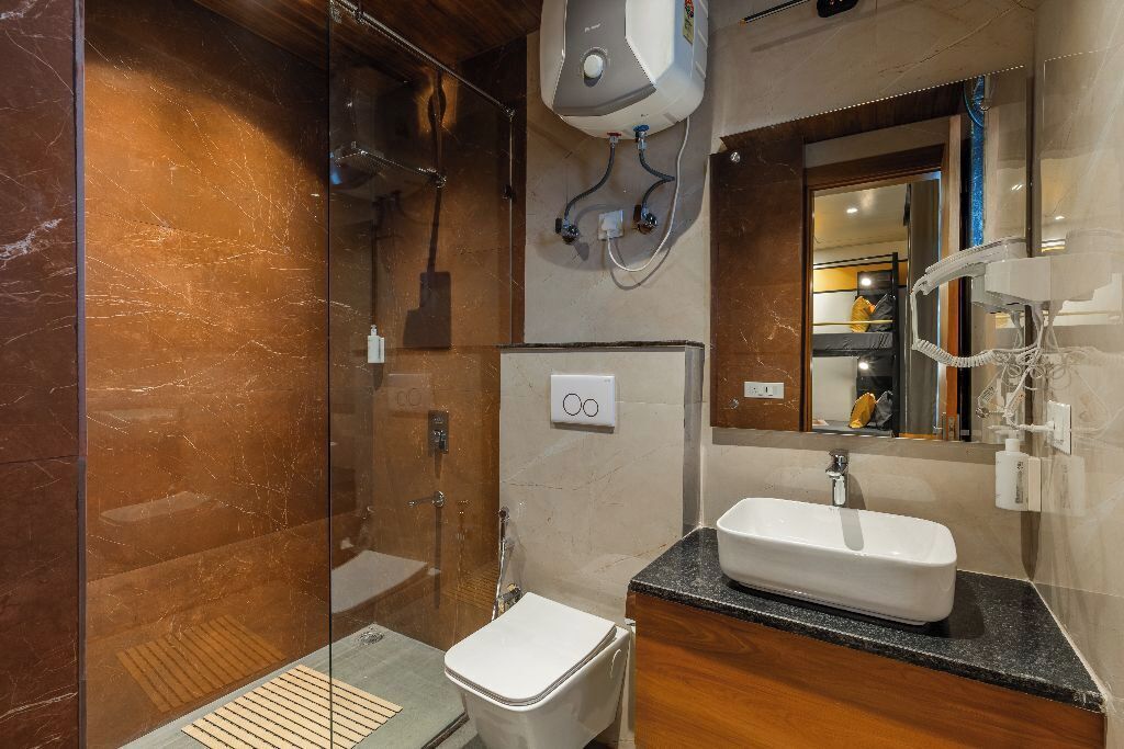 A modern bathroom with a glass-enclosed shower, a white sink, and a mirror above the sink.