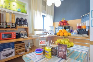 A breakfast buffet with various food items, a coffee station, and a fruit display. - Hotel Nuova Medusa (Rimini)