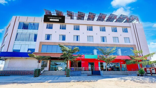 A hotel with a sign reading "TOWNHOUSE & Company Serviced Apartments" and solar panels on the roof. - Hotel Fortune Prime (Jaipur)