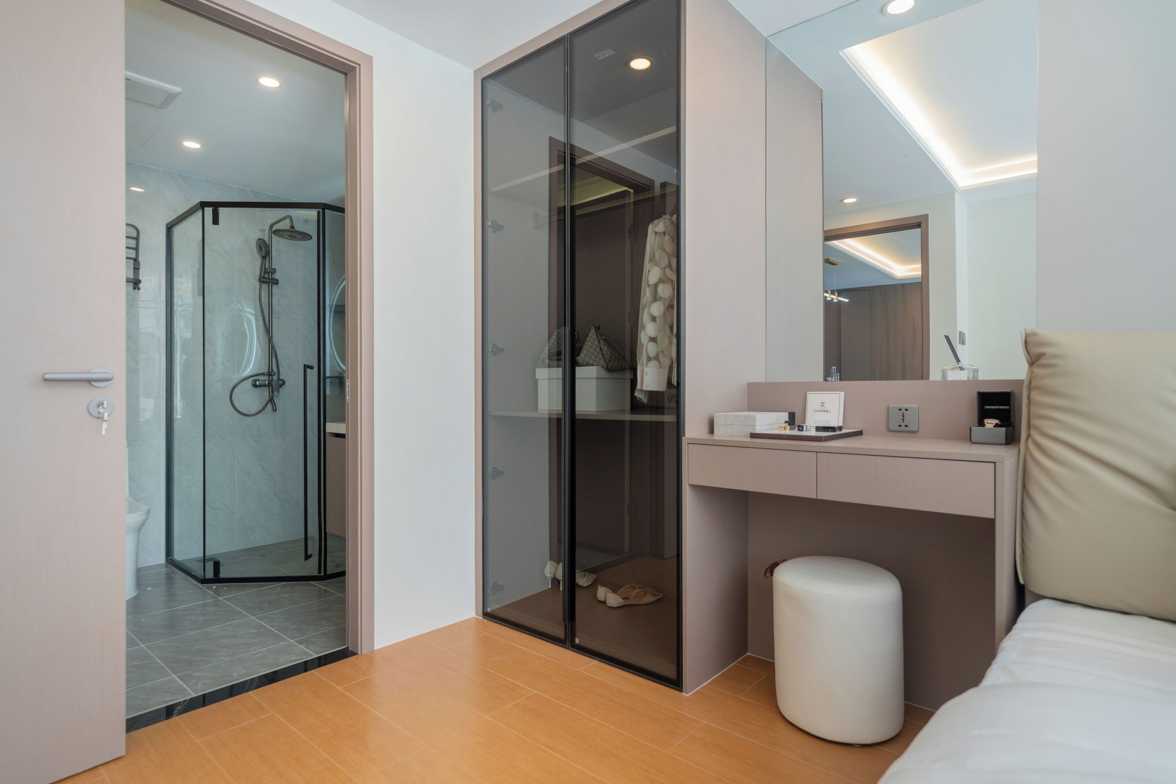 A modern bathroom with a glass shower enclosure, a vanity with a mirror, and a toilet.