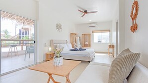 A modern hotel room with a bed, a sofa, a dining table, and a balcony. - Tom Star Pool Villa Layan 3BR Large pool, mountain view for the rooftop (ตำบล ศรีสุนทร)