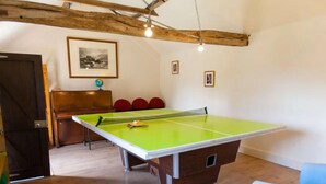 A room with a ping pong table, wooden furniture, and a globe on a shelf. - Tranquil Cottage in a Countryside (Ashford)