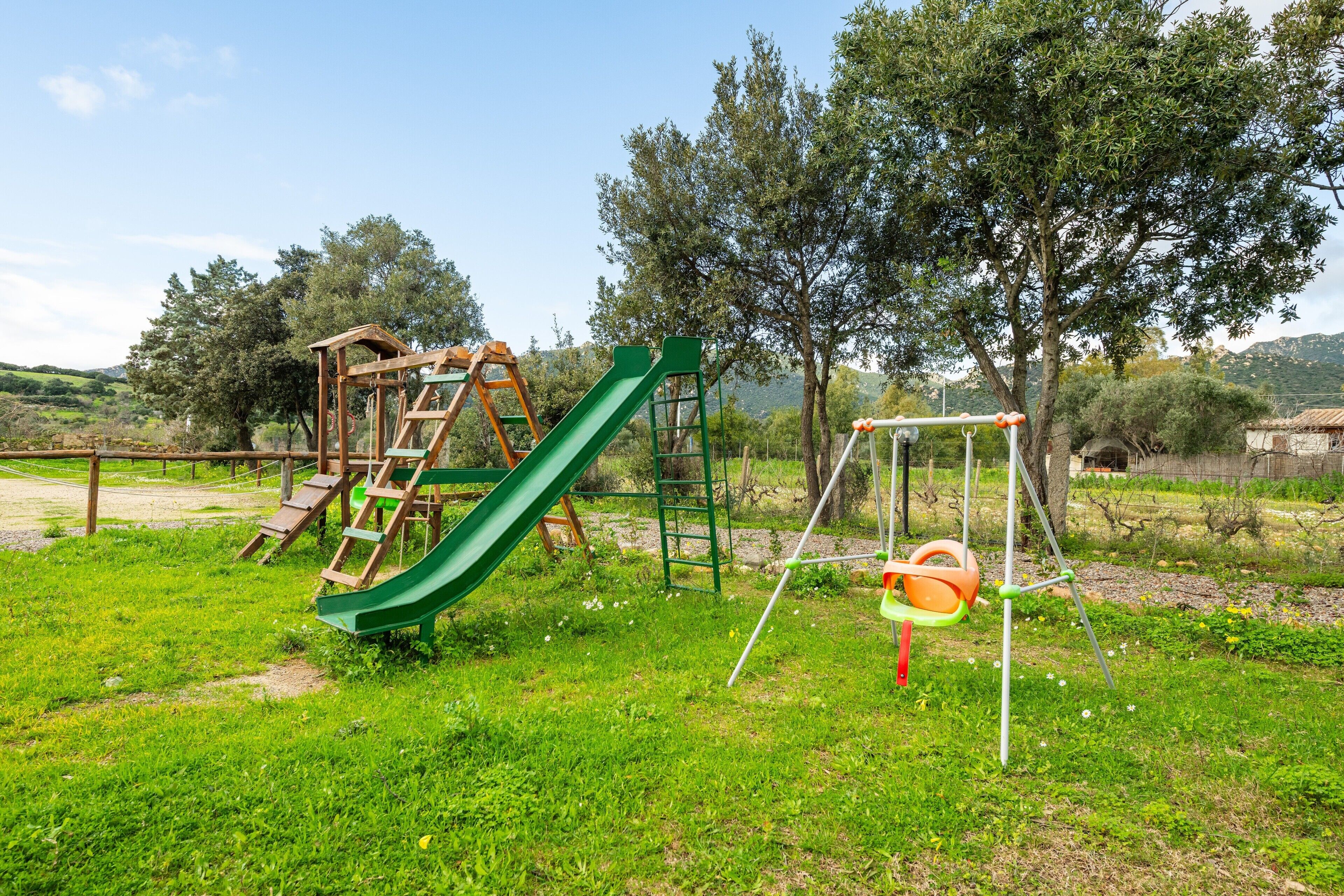 A playground with a slide and swings.