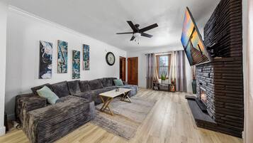 Smart TV, lareira, livros, aparelho de som