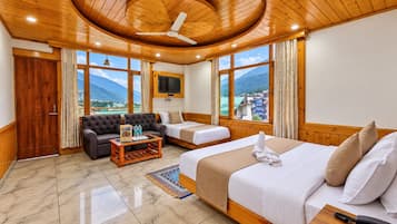 A hotel room with a bed, sofa, and a TV.
