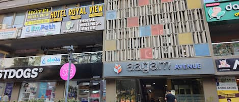 A building with multiple businesses including Hotel Royal View, EmPath Diagnostic Pathology Laboratory, and a Dental Wellness Centre.
