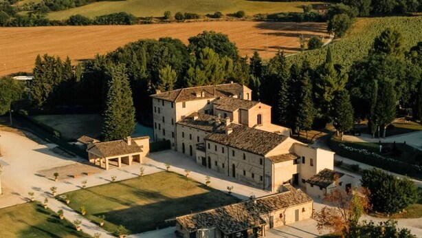 A large, historic building with multiple wings and a courtyard. - pieve san biagio (Macerata)