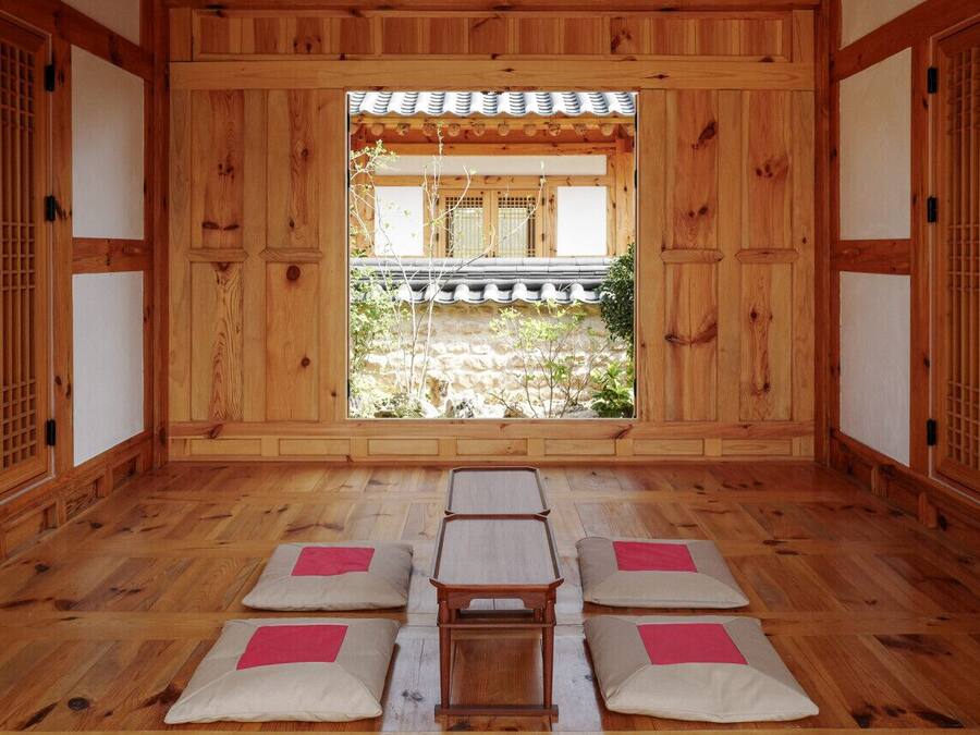A traditional Japanese room with tatami mats, a low table, and sliding doors.