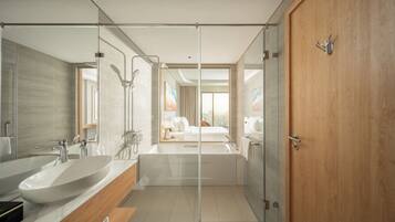 Une salle de bain moderne dotée d’une grande baignoire, de deux lavabos et d’une cabine de douche en verre.