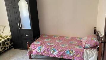 Una camera da letto con un letto, un armadio e una sedia.