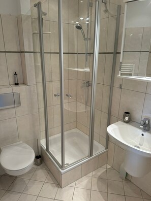 Shower, hair dryer, towels, toilet paper