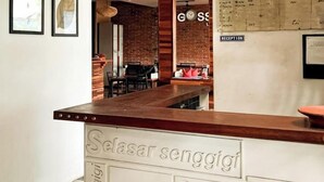 A hotel reception area with a modern staircase, a reception desk, and a visible reception counter. - Lacasa Senggigi By Royal Amreetha (Senggigi)