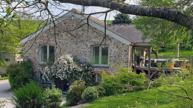 A stone house with a porch, surrounded by greenery and a gravel driveway. - Kerslake House (Torpoint)